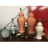 A pair of glazed terracotta colour hexagonal ginger jar style tablelamps, one with brass plinth; a