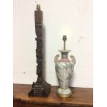 A hardwood tablelamp made from a carved tribal type totem pole column with steps to front, the