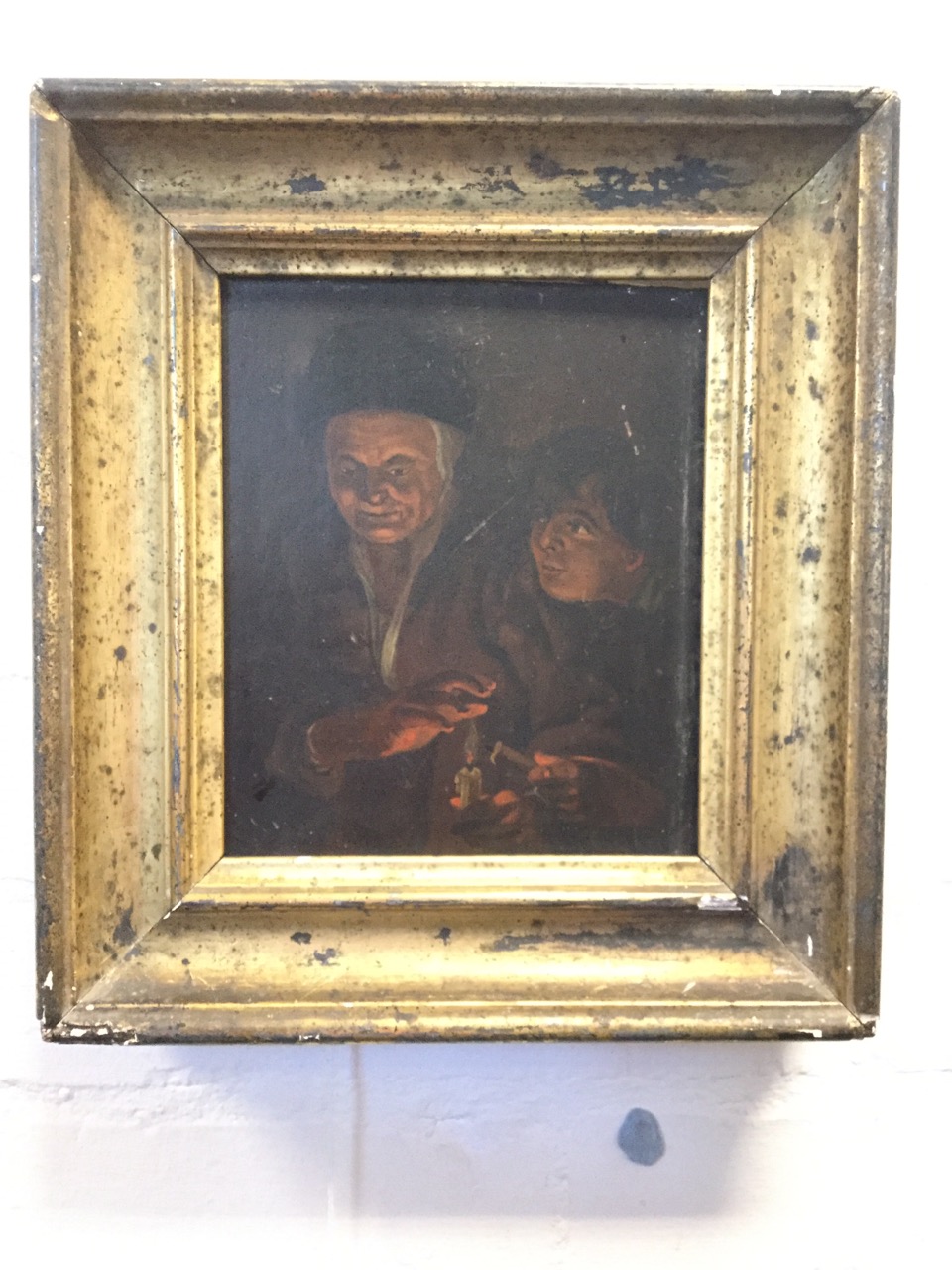 Nineteenth century oil on oak panel, dark candlelit scene with two figures, in gilt frame. (7in x