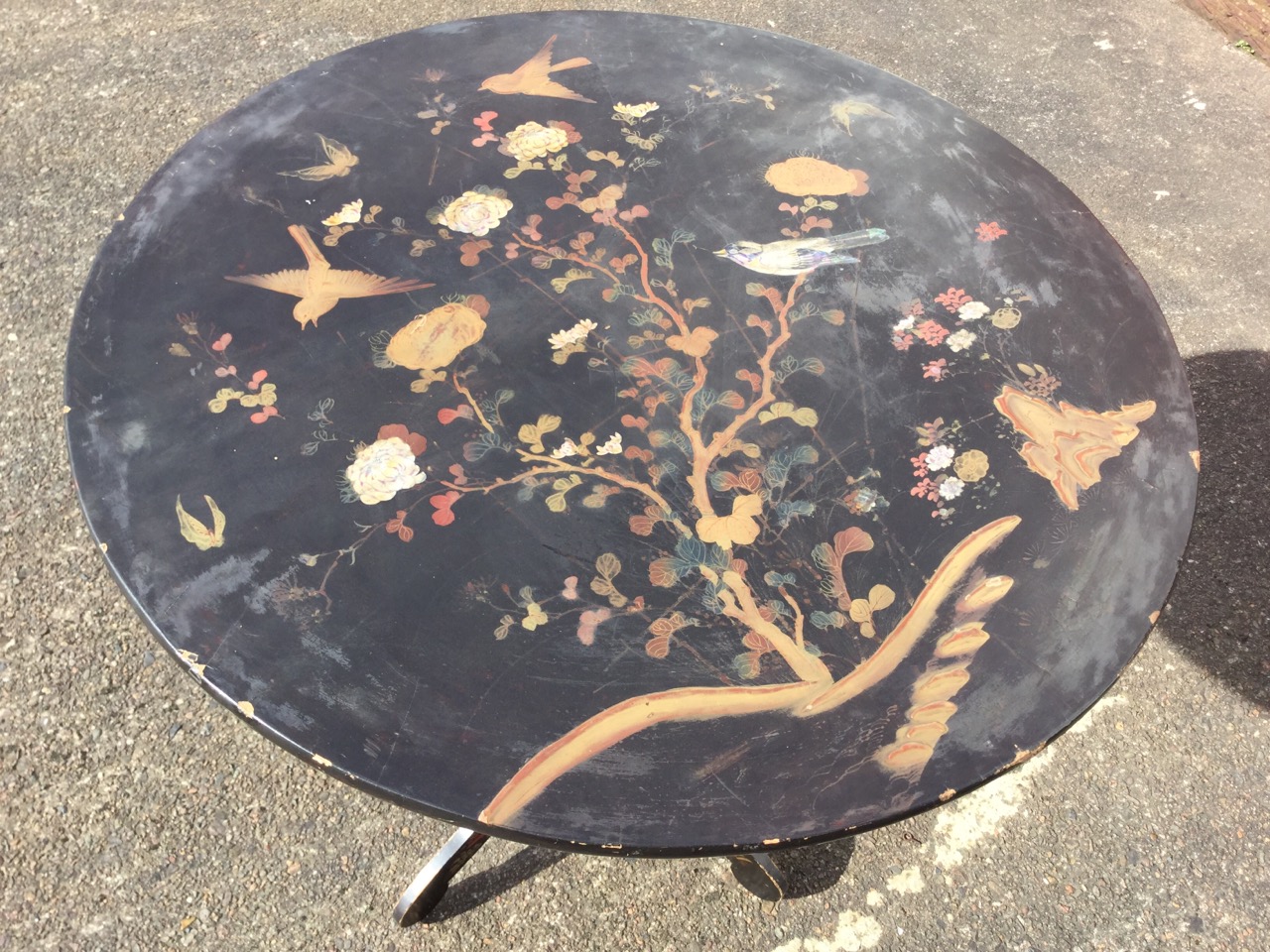 A circular Victorian Japanese lacquer tilt-top table, the top inlaid with mother-of-pearl and gilt