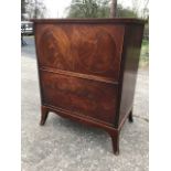 A Victorian mahogany commode, the hinged top above a drop-down panel inlaid with a pair of