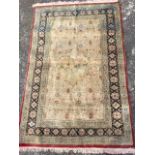 A fine silk rug woven with central scalloped landscape medallion on rectangular floral field, within