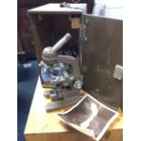 A cased Swift SLR microscope, the scientific instrument in locking box complete with slides, phails,
