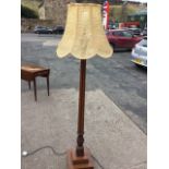 A Victorian mahogany standard lamp with tapering cluster column having leaf carved collars raised on