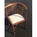 An Edwardian mahogany corner chair, the bow back inlaid with boxwood stringing above a wheel pierced