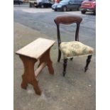 A single Victorian mahogany dining chair with rounded back above an upholstered seat raised on