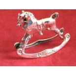 A miniature silver rocking horse modelled with saddle & bridle, on shaped rockers - 925 silver