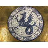 A circular delft style blue & white tin glazed ceramic plaque painted with a cockerel within a