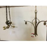 An Edwardian light fitting with acanthus leaf embossed brass ceiling rose supporting three chains,