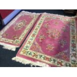 A Chinese thick pile wool rug woven with oval floral medallion on pink field framed by ivory