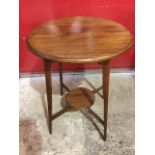 A circular Edwardian mahogany lamp table, the moulded top on angled square tapering legs joined by