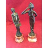 A pair of art nouveau style bronze figurines, one lady with serving tray and the other blowing a