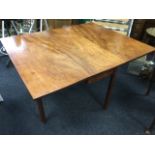A nineteenth century mahogany dining table, the rectangular top with two drop-leaves raised on