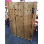 A nineteenth century Welsh pine country cupboard with tongue & groove plank door enclosing