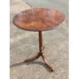 A nineteenth century circular mahogany lamp table, the top with moulded edge supported on a turned