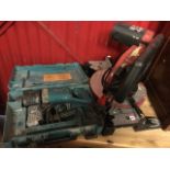 A Rexon Laser electric mitre saw, the machine on turntable stand; and a cased Makita power drill. (