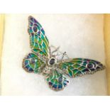 A silver plique enamel butterfly brooch, the wings with coloured panels set with sapphires, having