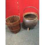 A handbeaten Victorian copper cauldron shaped coal scuttle on three angled feet, mounted with iron