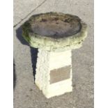 A composition stone garden birdbath with octagonal bowl on square tapering brick moulded column,