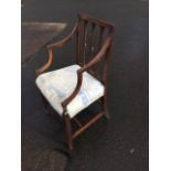 A nineteenth century mahogany armchair, the back with channelled frame and arms, having three leaf