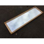 A modern mirror with bevelled plate in moulded gilt frame, having coppered leaf mounts to
