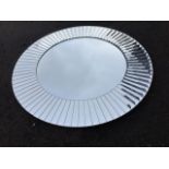A contemporary circular mirror, the plate framed by ribbed bevelled border. (30in dia)