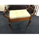 An Edwardian mahogany dressing table or piano stool, the upholstered hinged seat above box