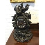 A nineteenth century carved black forrest clock surmounted by hens & chicks with leaves, the base