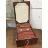 An Edwardian leather travelling case with brass military style handle to hinged lid, the box