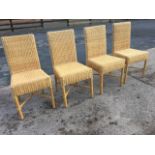 A set of four cane dining chairs with rectangular woven backs above box seats, raised on turned legs