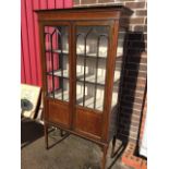 An Edwardian boxwood strung mahogany display cabinet, with moulded cornice above inlaid dentil band,