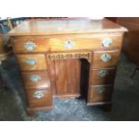 An eighteenth century mahogany kneehole desk, the rectangular moulded top above a long frieze