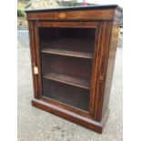 A Victorian rosewood cabinet, the top with ebonised mouldings above an inlaid frieze, the boxwood