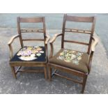 A married pair of open armchairs, the backs with twin rails framing beads, having shaped arms
