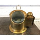 A brass lifeboat binnacle, the domed case with ring handle having circular glazed window enclosing a