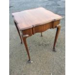 A square George II style mahogany table with scalloped moulded top above a rippled frieze with