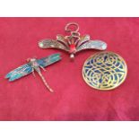 A copper dragonfly brooch with enamelled wings and red stone eyes, having hinged pin to verso; a