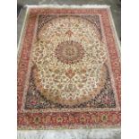An oriental style chenille rug woven with circular floral medallion on entwined ivory field having