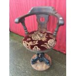 A Victorian marine oak captains chair, the rounded back with hole pierced splat having arms on