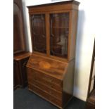 An Edwardian mahogany bureau bookcase with moulded dentil cornice above frieze inlaid with satinwood