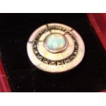 A deco style 925 silver hallmarked ring of shield target form, having central bezel mounted opal