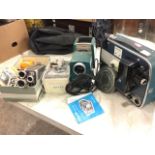 A Brownie 8mm movie camera and a cased Brownie projector with spare spools; a Kodak slide projector;