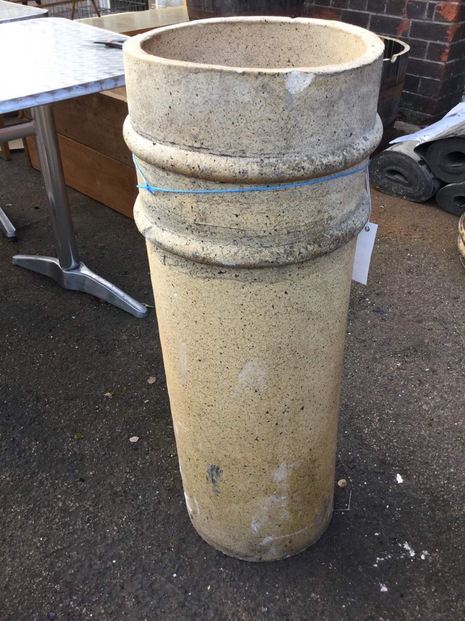 A tubular stoneware chimney pot moulded with two ring bands. (33in)