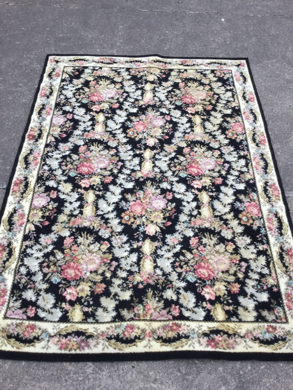 A Spanish Whitney wool rug woven in the Escorial pattern with field of flowers on black ground - Image 2 of 3