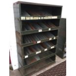 A 3ft metal storage rack with six stacking sections, having many shaped tapering dividers. (36in x