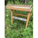 A Victorian pine dairy table, the tray top with angled sides supported on rectangular legs &