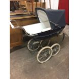 A Silver Cross pram, the lined metal body mounted with canvas concertina hood and chrome handle,