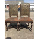 A pair of nineteenth century carolean style walnut side chairs, the studded embossed leather backs &