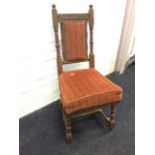 A nineteenth century German oak side chair, the back with upholstered panel framed by turned columns