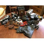 A collection of cameras, lenses, light metres, etc., including some Victorian mahogany cased, a